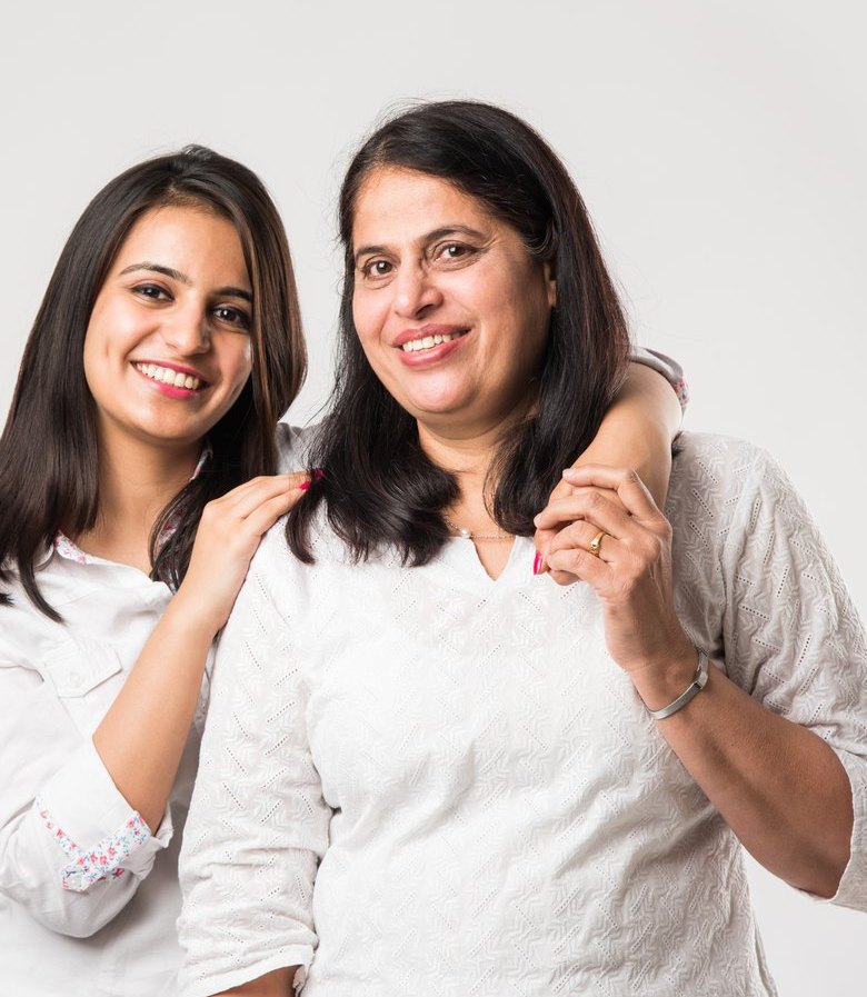 A mother and daughter smiling together